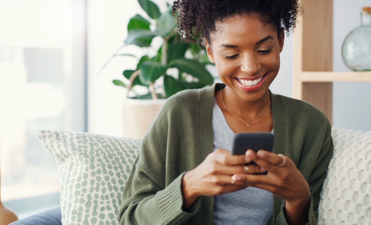 A woman taking a quiet moment with her phone at home