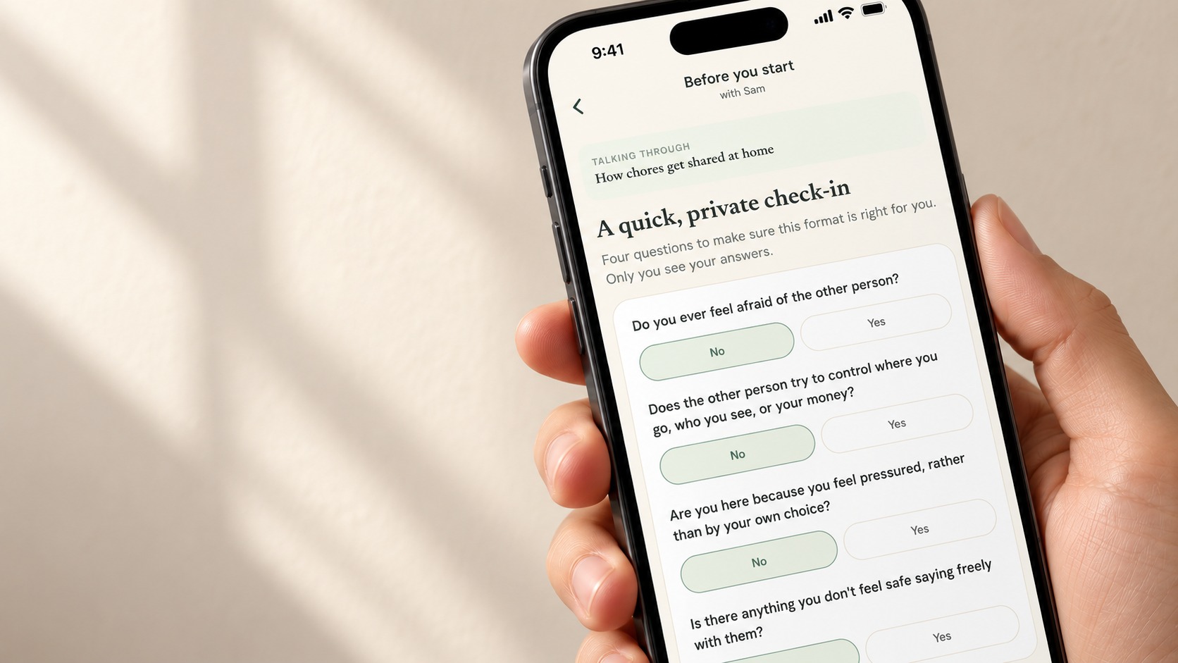 A hand holding a phone showing the private safety check-in